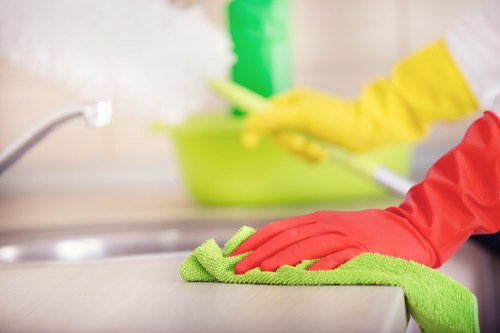 Professional cleaner maintaining kitchen surfaces in Westhampstead